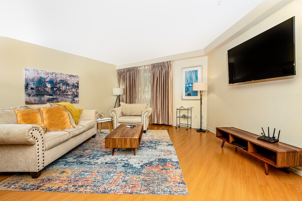 a living room with a couch and two chairs and a coffee table